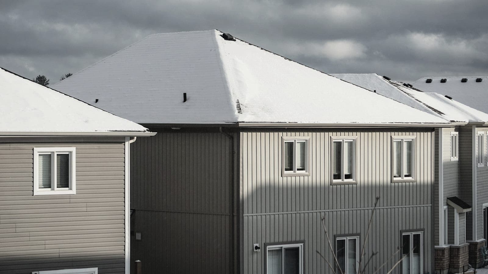 Snow lying on a row of pitched house roofs