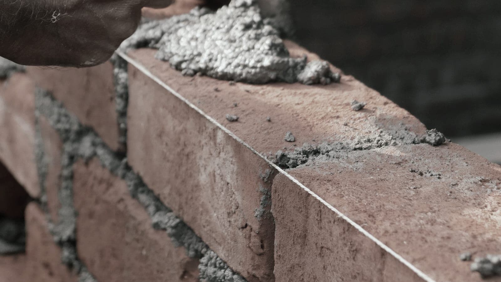 Mortar being laid on a course of bricks